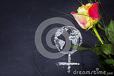 Rose and a chalk drawn female sign with earth globe on a blackbo Stock Photo