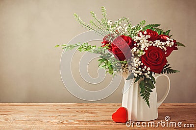 Rose flower bouquet and heart shape box on wooden table with copy space Stock Photo