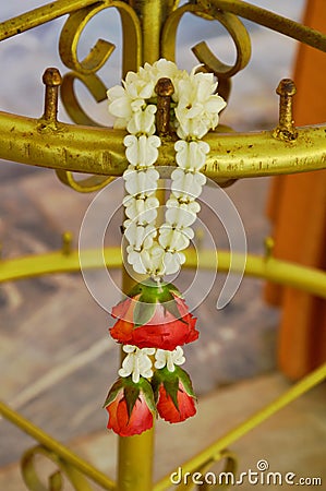 Rose garland wreathe on brass pole Stock Photo