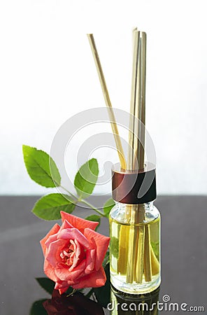 Rose scented oil bottle with wooden sticks Stock Photo