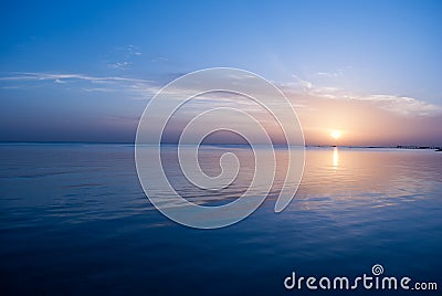 Rose sunrise on the ocean. Sun under the red sea in the morning. Sunset and reflex on water in the evening. Sunrise and blue sky Stock Photo