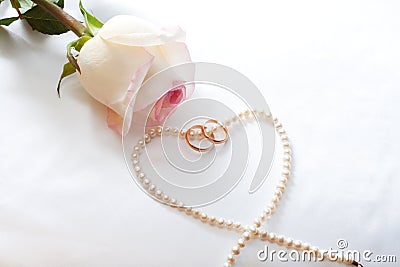 Rose, wedding rings, perl necklace Stock Photo