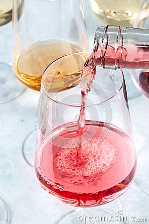 Rose wine pour at a tasting. Winetasting event. Elegant wineglass Stock Photo