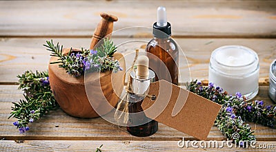 Rosemary aromatherapy. Essential oil and cosmetics, blank tag, banner. Wooden table background Stock Photo