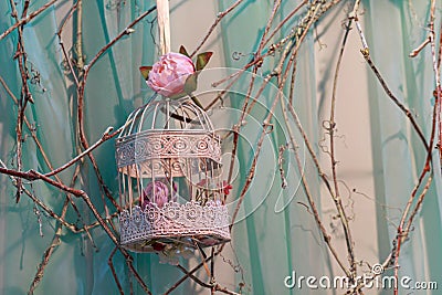 Roses and beautiful vintage bird's cage Stock Photo