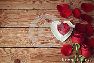 Roses and flower petals on wooden background with copy space. Valentine's day concept Stock Photo