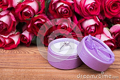 Roses and purple gift box with ring Stock Photo