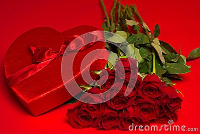 Roses and a red heart box on a red background Stock Photo