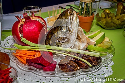 Rosh Hashanah, dish with the fish head, fruits and vegetables Stock Photo