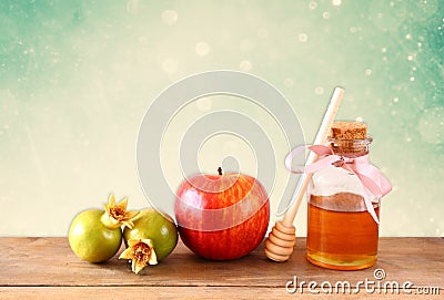 Rosh hashanah (jewesh holiday) concept - honey, apple and pomegranate over wooden table. traditional holiday symbols. Stock Photo