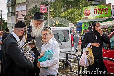 Rosh Hashanah, Jewish New Year 5777. During the mass holiday, the Hasid pilgrim sells religious literature. Editorial Stock Photo