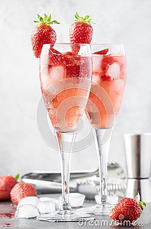 Rossini alcoholic cocktail with Italian sparkling wine, strawberry puree and ice in champagne glasses, place for text, selective Stock Photo