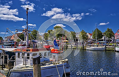 Rostock, Germany - Colorful Fishing boats resting in the peaceful canal on this spring hot day in WarnemÃ¼nde, Mecklenburg Editorial Stock Photo