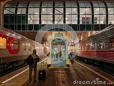 Rostov-on-Don, Russia - Circa November 2018 : Railways Station of RZD in Rostov-on-Don at night, Passenger train and platform Editorial Stock Photo