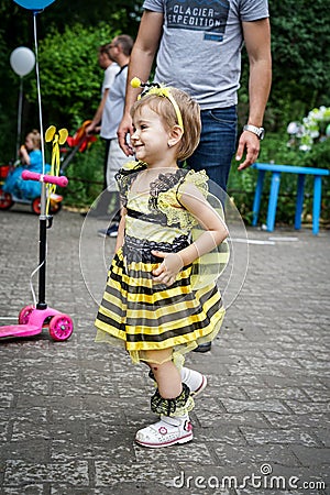 ROSTOV-ON-DON, RUSSIA - 20 May, 2018. Festival Ball of Babies. A beautiful little girl and in a festive dress and carnival mask Editorial Stock Photo