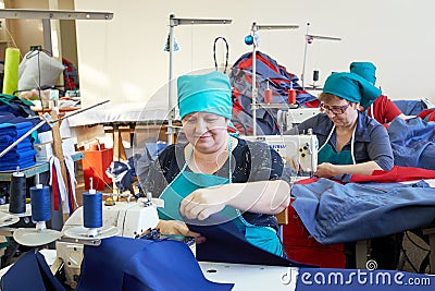 Group of adult women, seamstresses at the garment factory. Editorial Stock Photo