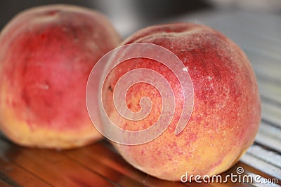 Rosy ripe Kuban peach close-up on a metal table Stock Photo