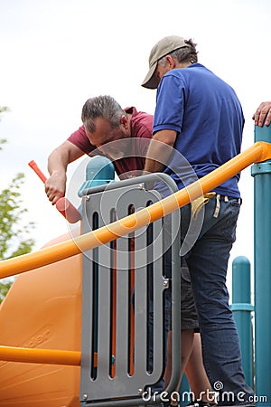 Rotary members from the community helping to build a playground for children. Editorial Stock Photo