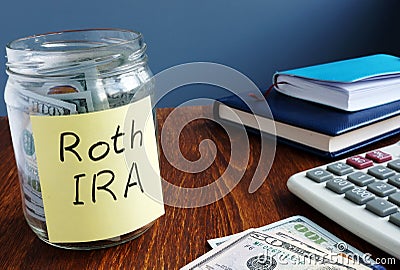 Roth ira written on a label of jar with money Stock Photo