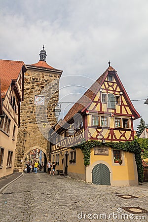 ROTHENBURG, GERMANY - AUGUST 29, 2019: Siebersturm tower and Spitalgasse street in Rothenburg ob der Tauber, Bavaria Editorial Stock Photo