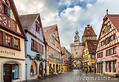 Tourists walk along beautiful streets in Rothenburg ob der Tauber Editorial Stock Photo