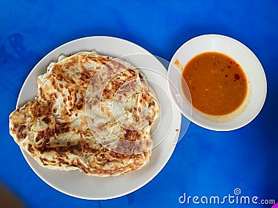 Roti canai with curry Stock Photo