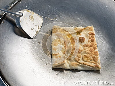 Roti. Fried flour with banana and egg. Stock Photo