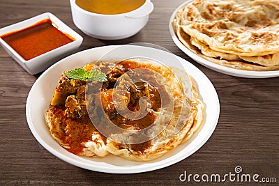 Roti Parata or Roti canai with lamb curry sauce Stock Photo