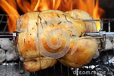 Rotisserie chicken on the grill Stock Photo