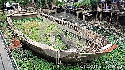 Rotted and abandoned row wooden boat Stock Photo