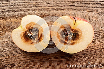 Rotten apple on wood background Stock Photo