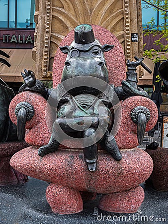 Rotterdam, Netherlands - April 28, 2022: A funny modern sculpture of a sitting businessman with the head of a hippopotamus, with Editorial Stock Photo