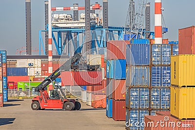 container loader is loading at huge container terminal Editorial Stock Photo