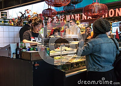 Inside market hall showing food court area with take away oriental chinese asian food vendor Editorial Stock Photo