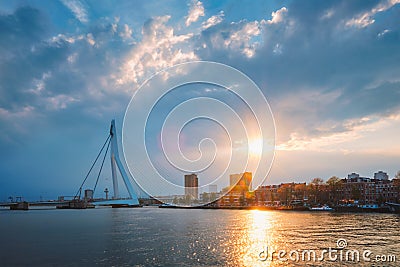 Rotterdam skyline cityscape with Erasmusbrug bridge over Nieuwe Maas in contre-jur on sunse, Netherlands. Editorial Stock Photo