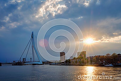 Rotterdam skyline cityscape with Erasmusbrug bridge over Nieuwe Maas in contre-jur on sunse, Netherlands. Editorial Stock Photo