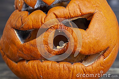 carved from pumpkin frightening face in mold and mildew during decomposition Stock Photo