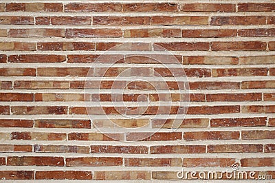 Rough, aged brick wall laid in running bond style, classic one-over-two pattern using narrow, long terracotta bricks Stock Photo