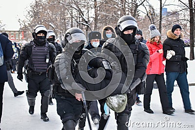 Rough detention of teenager at meeting in support of Alexei Navalny. Arrest of protester. The police in helmets are leading detain Editorial Stock Photo