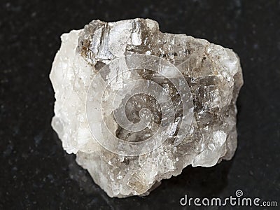 Rough Halite rock salt stone on dark Stock Photo