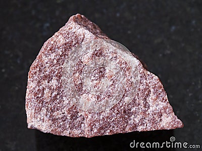 rough pink Quartzite stone on dark background Stock Photo