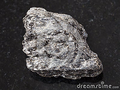 rough quartz-biotite schist stone on dark Stock Photo