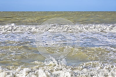 The rough sea - Storm surge with waves, foam and muddy water Stock Photo