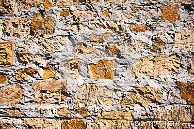 Rough textured wall made of bricks, stones, concrete Stock Photo