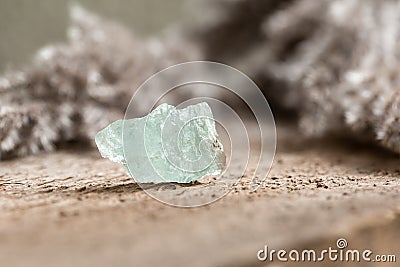 Rough Uncut Pale Blue Aquamarine Gemstone on Wood Stock Photo
