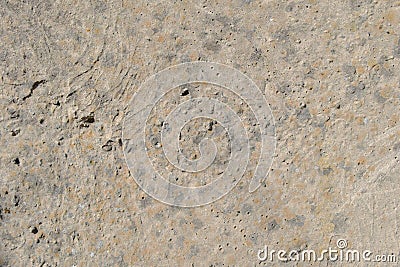 The rough, uneven surface of the cement wall is gray-brown Stock Photo