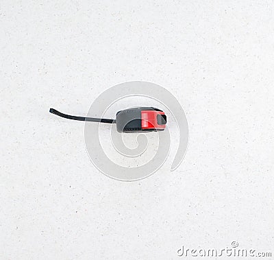 Roulette isolated on a light background close up. Black and red construction tape measure. Meter with a lace. Stock Photo