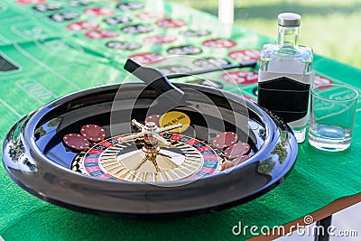 Roulette on the table with a glass and a bottle Stock Photo
