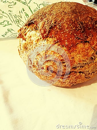 Round baked bread on white cloth round baked bread on white cloth,homemade bread with integral flour Stock Photo