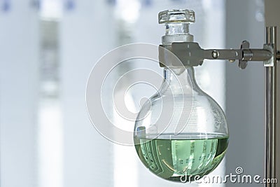 Round bottom flask with green liquid. Stock Photo